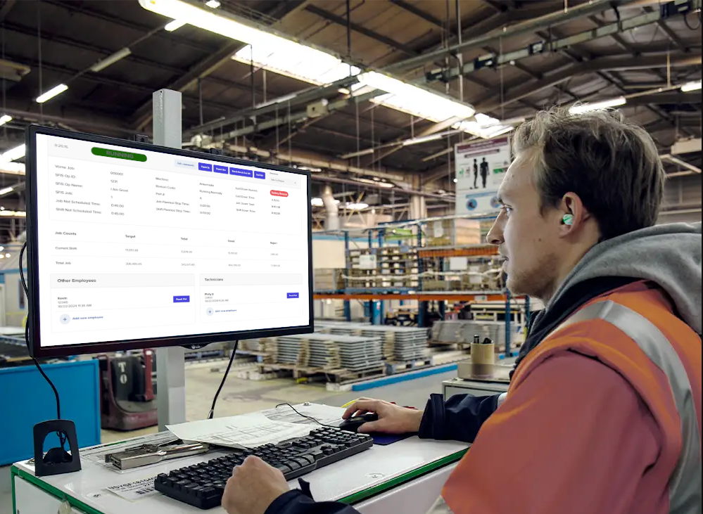 Man using the OEE Work Tracker on a pc on a factory floor